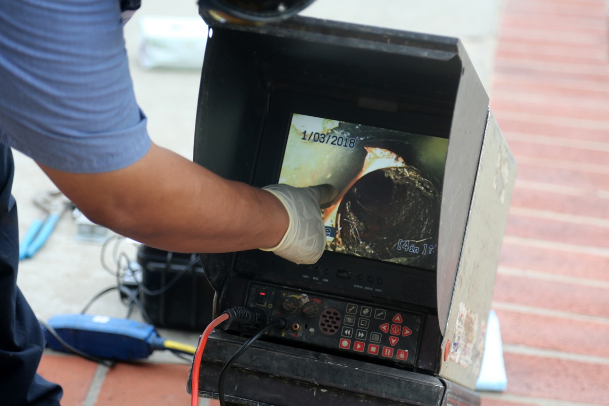 Licensed plumber performing a sewer scope inspection
