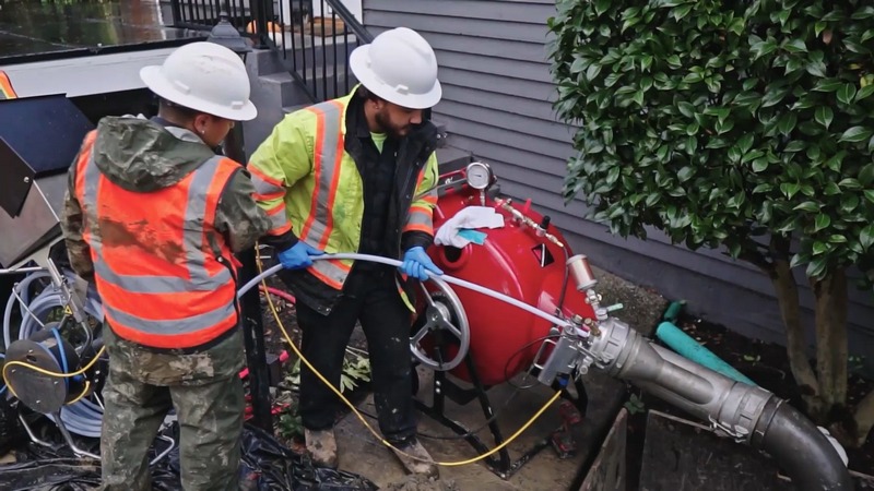 Licensed plumber performing hydro jetting service.
